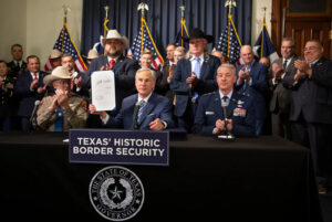 Gov. Greg Abbott displays Senate Bill 1900, one of six bills he signed during a legislation signing ceremony in Austin on June 8, 2023. Credit: Joe Timmerman/The Texas Tribune